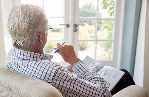 Elderly gentleman doing crossword